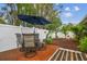 Outdoor dining area and lush landscape in a backyard with a privacy fence at 5744 Thrush Dr, New Port Richey, FL 34652