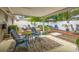 Backyard patio with multiple sitting areas, plants and a white privacy fence at 5744 Thrush Dr, New Port Richey, FL 34652