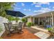 Outdoor patio area with dining table, umbrella, lush landscaping, and a serene, inviting atmosphere at 5744 Thrush Dr, New Port Richey, FL 34652