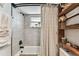 Bathroom with decorative shelves, tile flooring and shower with modern fixtures at 5744 Thrush Dr, New Port Richey, FL 34652