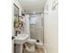 Bathroom with walk in shower, decorative shelves and modern fixtures at 5744 Thrush Dr, New Port Richey, FL 34652