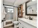 Bathroom with decorative shelves, tile flooring and shower with modern fixtures at 5744 Thrush Dr, New Port Richey, FL 34652