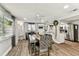 Open-concept dining area featuring a rustic table, stylish seating, and seamless flow into the kitchen at 5744 Thrush Dr, New Port Richey, FL 34652