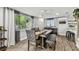 Comfortable dining room with a ceiling fan, rustic table, and ample natural light from the window at 5744 Thrush Dr, New Port Richey, FL 34652