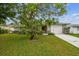 Charming home with a well-manicured lawn and mature tree, creating a welcoming curb appeal at 5744 Thrush Dr, New Port Richey, FL 34652