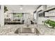 Open kitchen featuring granite countertop, large sink, and view into the dining area at 5744 Thrush Dr, New Port Richey, FL 34652