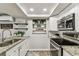 Updated kitchen with modern appliances, granite counters, and well-organized storage at 5744 Thrush Dr, New Port Richey, FL 34652