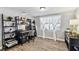 Dedicated office space with contemporary decor, ample storage shelves, and a bright window with natural light at 5744 Thrush Dr, New Port Richey, FL 34652