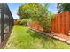 Landscaped backyard with an orange fence and healthy green grass at 6289 107Th N Ave, Pinellas Park, FL 33782