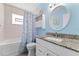 Bathroom featuring granite countertop and a seashell-themed shower curtain at 6289 107Th N Ave, Pinellas Park, FL 33782