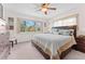Comfortable bedroom with a ceiling fan and a large window bringing the outdoors in at 6289 107Th N Ave, Pinellas Park, FL 33782