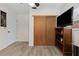 Bedroom with wood-look floors, sliding closet doors, and a TV on a shelf at 6289 107Th N Ave, Pinellas Park, FL 33782