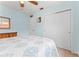 Bright bedroom featuring a large closet and a comfortable bed with blue patterned comforter at 6289 107Th N Ave, Pinellas Park, FL 33782
