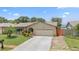 Charming home with a two-car garage, manicured lawn, and lush landscaping at 6289 107Th N Ave, Pinellas Park, FL 33782