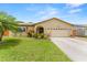 Charming home featuring a well-manicured lawn, lush landscaping, and an attached two-car garage at 6289 107Th N Ave, Pinellas Park, FL 33782