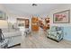 Open-concept living room featuring wood-look floors, neutral paint, and views to the back patio at 6289 107Th N Ave, Pinellas Park, FL 33782