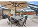 Outdoor patio with dining and seating areas with a view of the enclosed pool at 6289 107Th N Ave, Pinellas Park, FL 33782