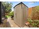 Exterior of the outdoor backyard shed with a stone base and adjacent foliage at 6289 107Th N Ave, Pinellas Park, FL 33782