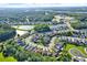 An aerial view of a vibrant, established neighborhood showcases a harmonious blend of homes and green spaces at 6439 Gentle Ben Cir, Wesley Chapel, FL 33544