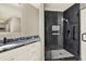 Modern bathroom featuring glass-enclosed shower, granite countertops, and white cabinets at 6439 Gentle Ben Cir, Wesley Chapel, FL 33544