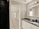 Bathroom with granite countertops and modern light fixture at 6439 Gentle Ben Cir, Wesley Chapel, FL 33544