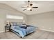 Cozy bedroom featuring a ceiling fan, a neutral color scheme, and a window for natural light at 6439 Gentle Ben Cir, Wesley Chapel, FL 33544