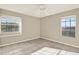 Bedroom with tile flooring, a ceiling fan, and two windows providing natural light at 6439 Gentle Ben Cir, Wesley Chapel, FL 33544