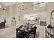 Open concept dining room with high ceilings, chandelier, and a view of the modern kitchen at 6439 Gentle Ben Cir, Wesley Chapel, FL 33544