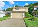 Inviting exterior of a two-story home featuring a two-car garage, lush lawn, and neatly landscaped front yard at 6439 Gentle Ben Cir, Wesley Chapel, FL 33544