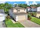 Well-maintained home exterior with a two-car garage, green lawn, and attractive landscaping enhancing curb appeal at 6439 Gentle Ben Cir, Wesley Chapel, FL 33544