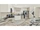 Close up of kitchen with granite countertops, stainless steel appliances, and white cabinets at 6439 Gentle Ben Cir, Wesley Chapel, FL 33544