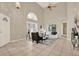 Bright living room with high ceilings, large windows, and stylish furniture creating an inviting atmosphere at 6439 Gentle Ben Cir, Wesley Chapel, FL 33544