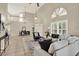 Spacious living area with tile floors, a large window, and a view of the adjacent dining area with chandelier at 6439 Gentle Ben Cir, Wesley Chapel, FL 33544