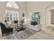 Cozy living room featuring a comfortable white sofa, modern rug, and plenty of natural light from sliding glass doors at 6439 Gentle Ben Cir, Wesley Chapel, FL 33544