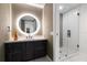 Contemporary bathroom with an illuminated round mirror and a glass-enclosed shower at 777 3Rd N Ave # 1304, St Petersburg, FL 33701