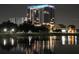 Night view of a modern high-rise building reflected in the still waters of a lake at 777 3Rd N Ave # 1304, St Petersburg, FL 33701