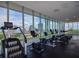 Bright gym featuring multiple exercise machines and floor-to-ceiling windows with city views at 777 3Rd N Ave # 1304, St Petersburg, FL 33701