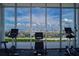 Bright gym featuring multiple exercise machines and floor-to-ceiling windows with city views at 777 3Rd N Ave # 1304, St Petersburg, FL 33701