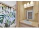 Bathroom with shower, vanity, sink, and mirror at 8451 Candlewood Rd # 8451, Seminole, FL 33777