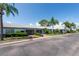 Charming single-story homes with attached garages, well-manicured lawns, and tropical landscaping under a bright blue sky at 8451 Candlewood Rd # 8451, Seminole, FL 33777