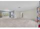 Spacious living room with neutral carpet and walls, providing a blank canvas for personal touches and décor at 8451 Candlewood Rd # 8451, Seminole, FL 33777