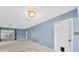 Cozy living room with a classic chandelier, light blue walls, and an entryway door, ideal for relaxation and gatherings at 8451 Candlewood Rd # 8451, Seminole, FL 33777