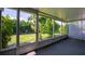 Enclosed screened in patio with view to the lush landscaping and backyard at 8451 Candlewood Rd # 8451, Seminole, FL 33777