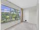 Enclosed room features windows with view of exterior, carpet flooring, and an entrance door at 8451 Candlewood Rd # 8451, Seminole, FL 33777