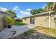 View of the backyard featuring a concrete patio, potted plant, and sliding glass door at 8537 93Rd Ave, Seminole, FL 33777
