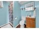 Bright blue bathroom featuring a shower, toilet, and vanity sink with wood cabinet at 8537 93Rd Ave, Seminole, FL 33777