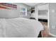 Well lit bedroom featuring a closet with mirrored sliding doors, TV and beach themed art at 8537 93Rd Ave, Seminole, FL 33777