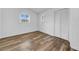 This bedroom features wood-look floors, two windows, neutral walls and a closet at 8537 93Rd Ave, Seminole, FL 33777
