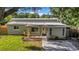 A single-Gathering home featuring a covered porch, mature landscaping, and a well-maintained lawn at 8537 93Rd Ave, Seminole, FL 33777