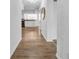 Bright hallway with wood floors leading to the open-concept kitchen and dining area at 8537 93Rd Ave, Seminole, FL 33777